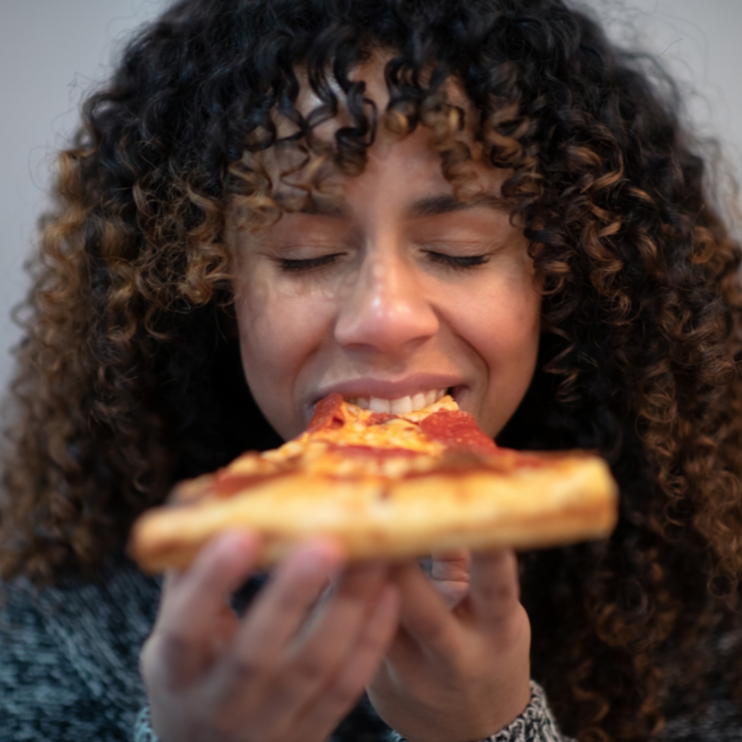 woman eating pizza