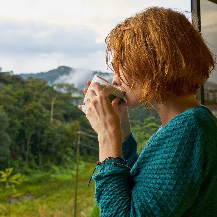 Woman drinking tea outdoors | Understanding Caffeine & Chronic Fatigue | Creative Balance Health